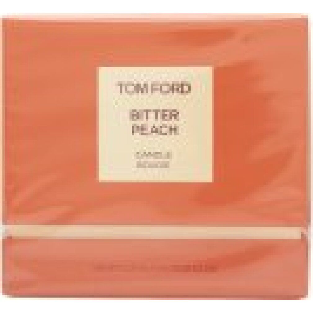 Quadratische Verpackung in Pfirsichfarben. Auf der Vorderseite ein cremefarbenes Etikett mit dem Markennamen Tom Ford und der Aufschrift Bitter Peach Candle.