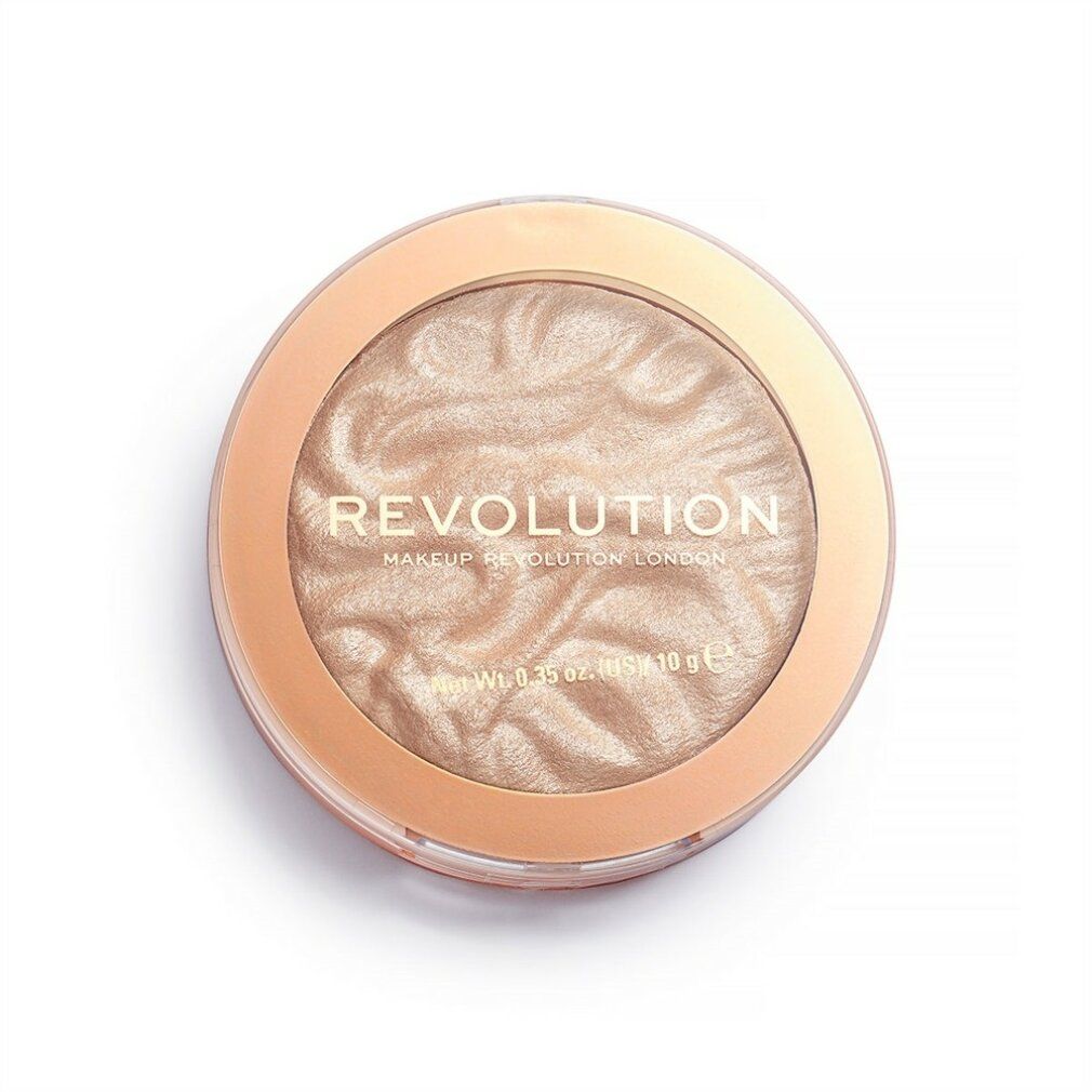 Runder Highlighter. Helle, cremefarbene Oberfläche. Umrandung in hellem Braun. Schriftzug: REVOLUTION. Net Wt. 0.35 oz (US) / 10 g e.