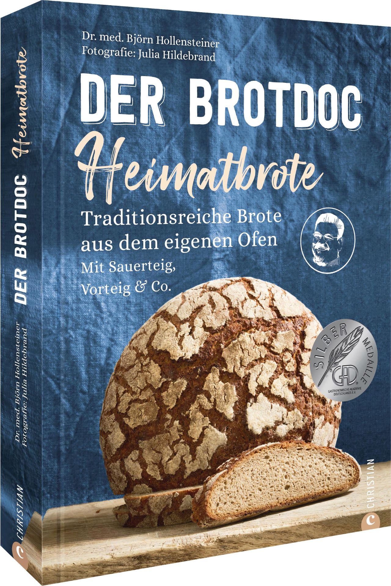 Buchcover: "Der Brotdoc Heimatbrote". Titel, Autor, Brotlaib und Scheibe. Silbermedaille.