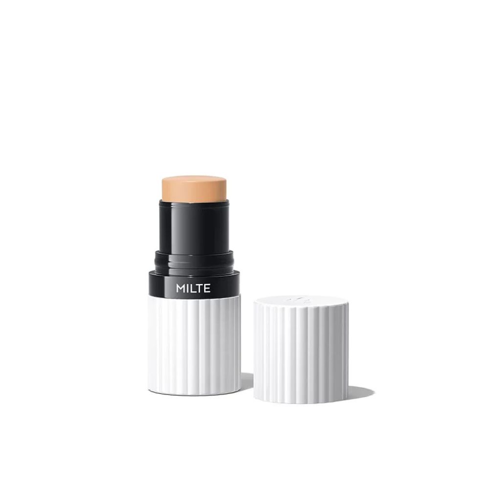 Foundation-Stick mit geöffneter Kappe. Weißer Behälter, schwarzer Deckel, heller Farbton.