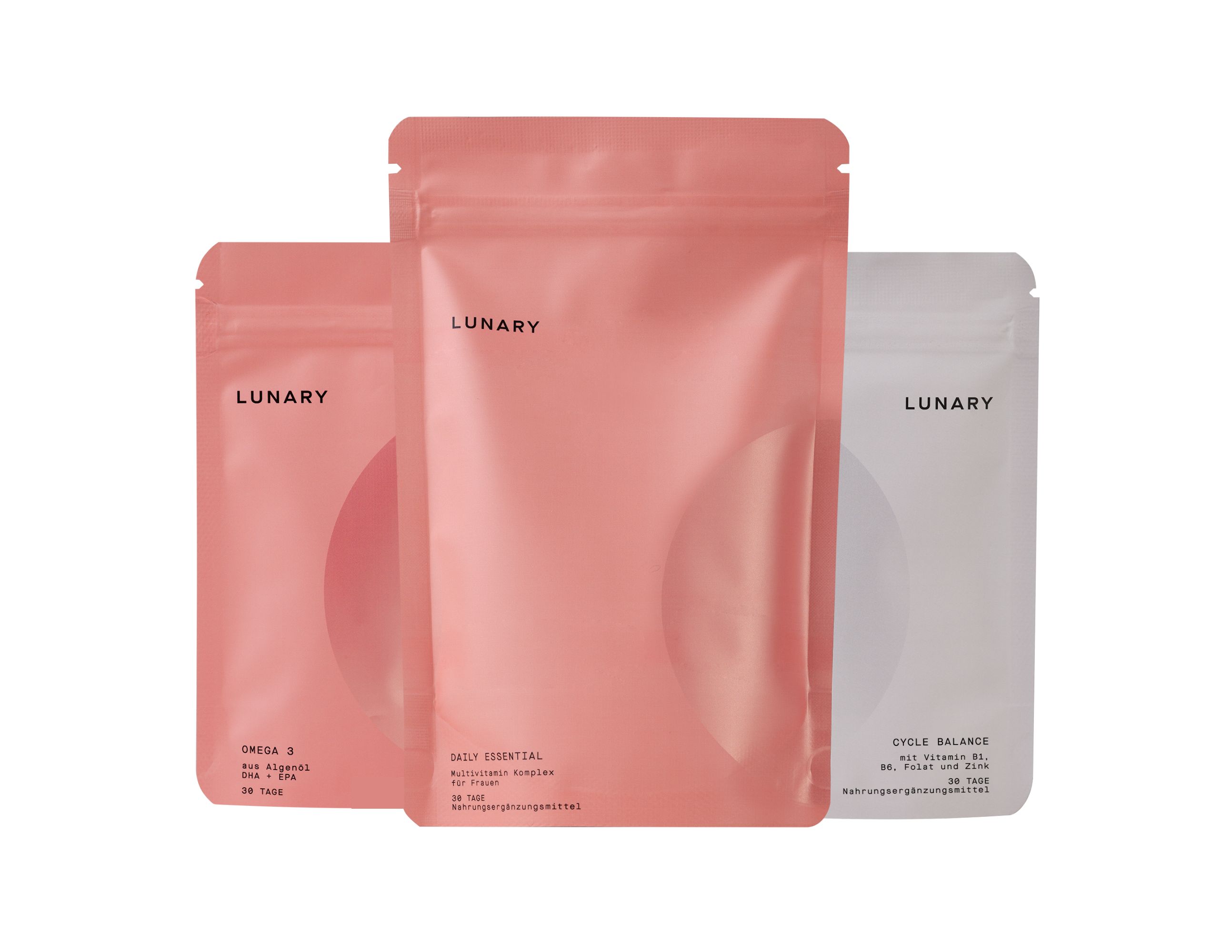 Drei Beutel. Rosa und weiß. Aufschrift: LUNARY. Produkt: Cycle Balance, Daily Essential, Omega 3.