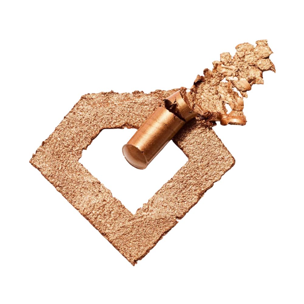 Goldfarbener Lidschattenstift und Abrieb in Diamantenform. Produktname nicht vollständig sichtbar.
