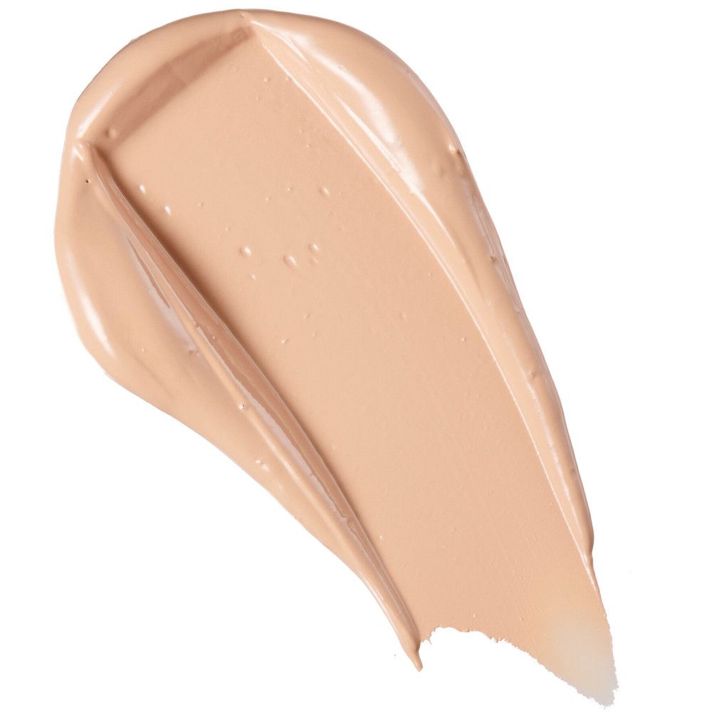 Heller Concealer-Farbton als Strich. Cremige Textur, helle Farbe. Auf weißem Hintergrund.