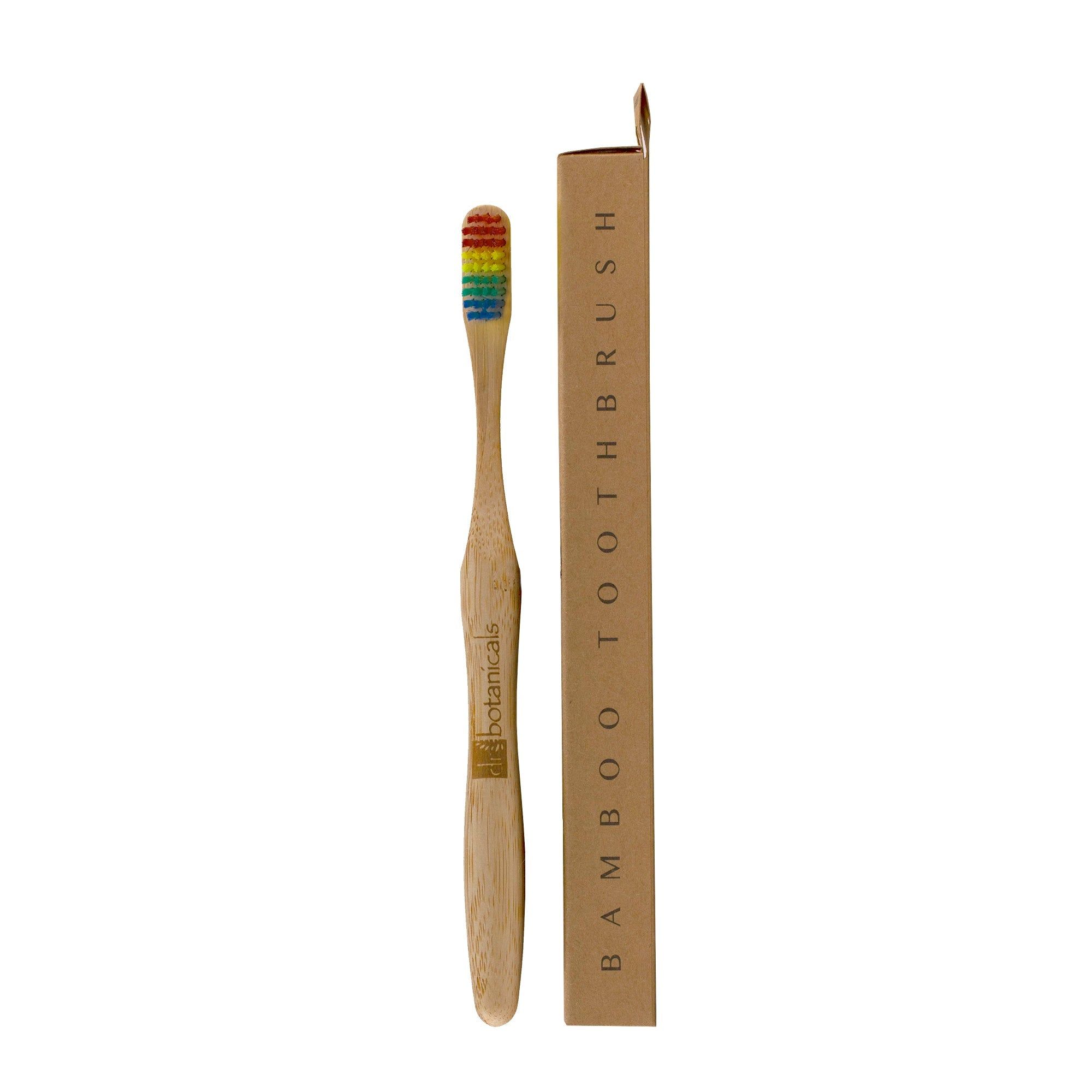 Bambus-Zahnbürste mit Regenbogenborsten und Verpackung. Aufschrift: "Bamboo Toothbrush". Marke: Dr Botanicals.