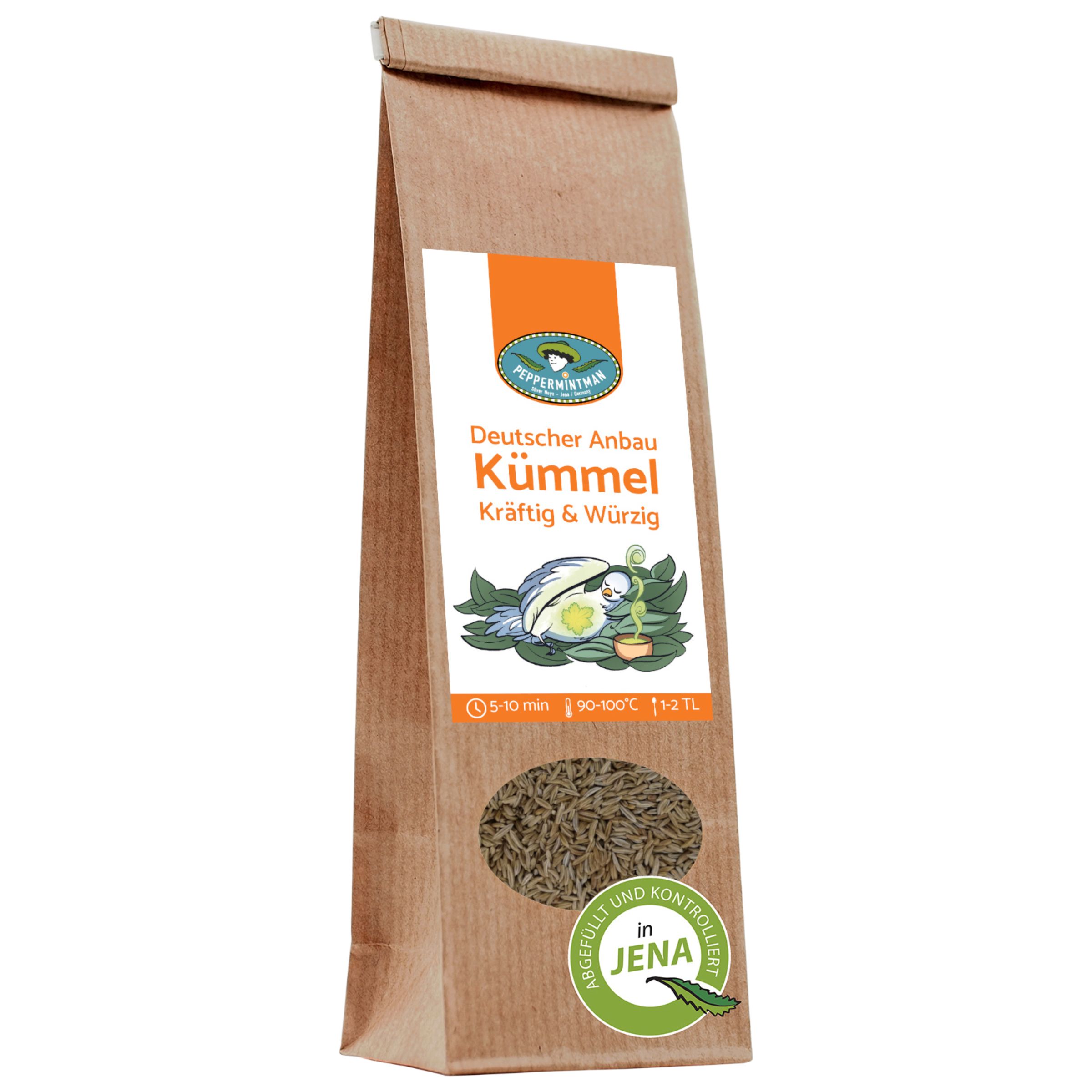 Braune Papiertüte mit Produktetikett. Aufschrift: Deutscher Anbau Kümmel. Sichtfenster mit Kümmelsamen.