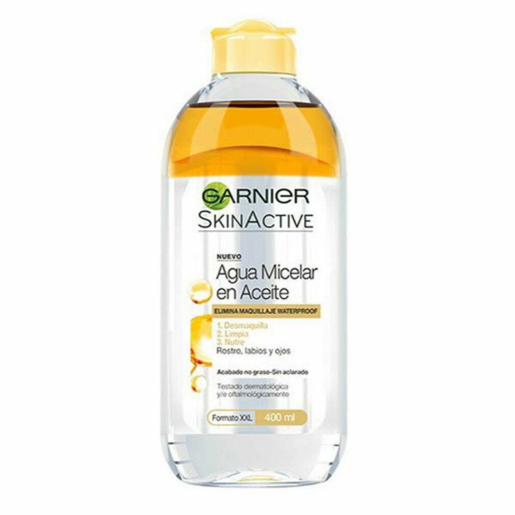 Klare Flasche mit gelber Flüssigkeit und gelbem Deckel. Aufschrift Garnier SkinActive, Agua Micelar en Aceite. 400 ml.