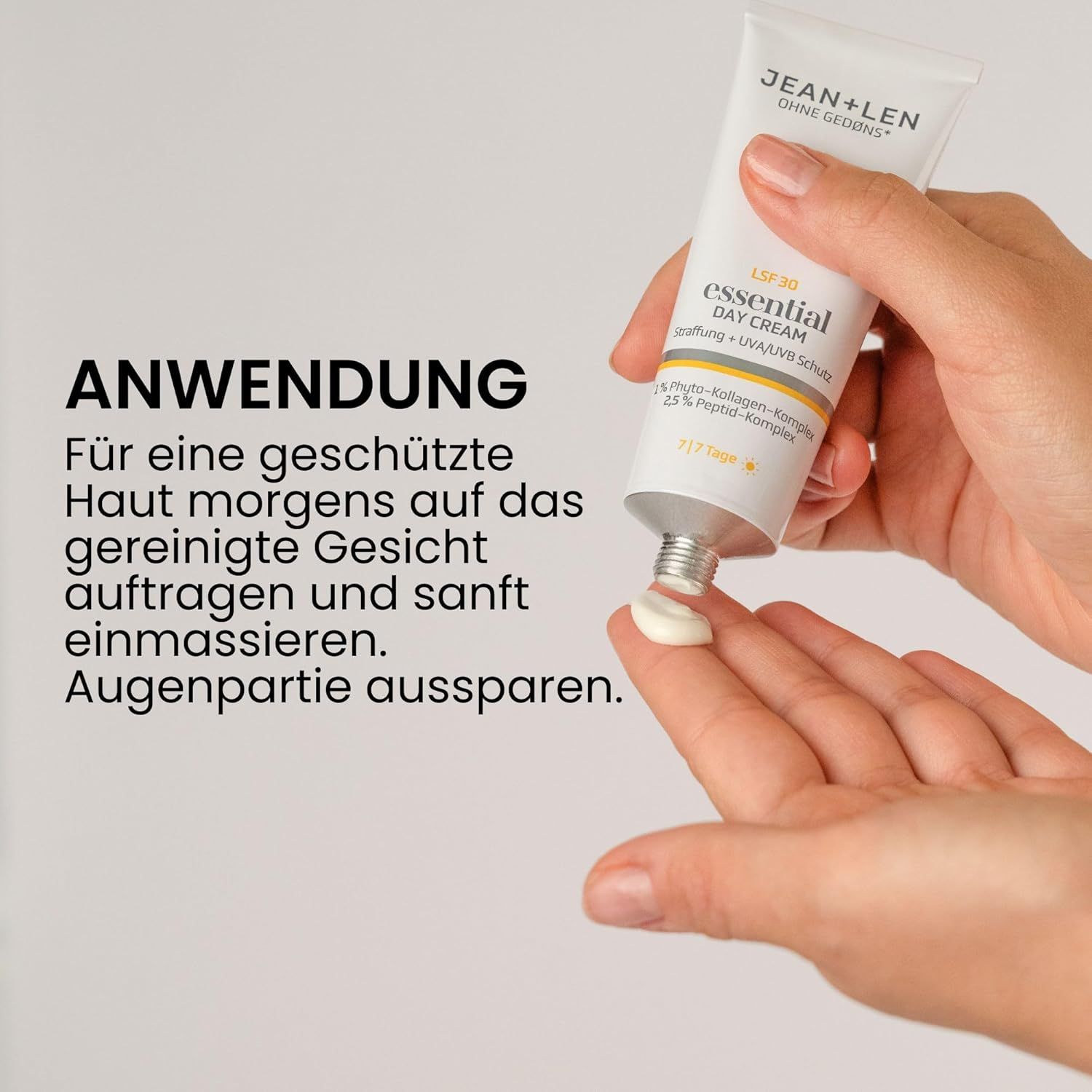 Hand hält Tube "Jean & Len essential DAY CREAM". Creme wird auf die Handfläche gedrückt. Text über Anwendung.