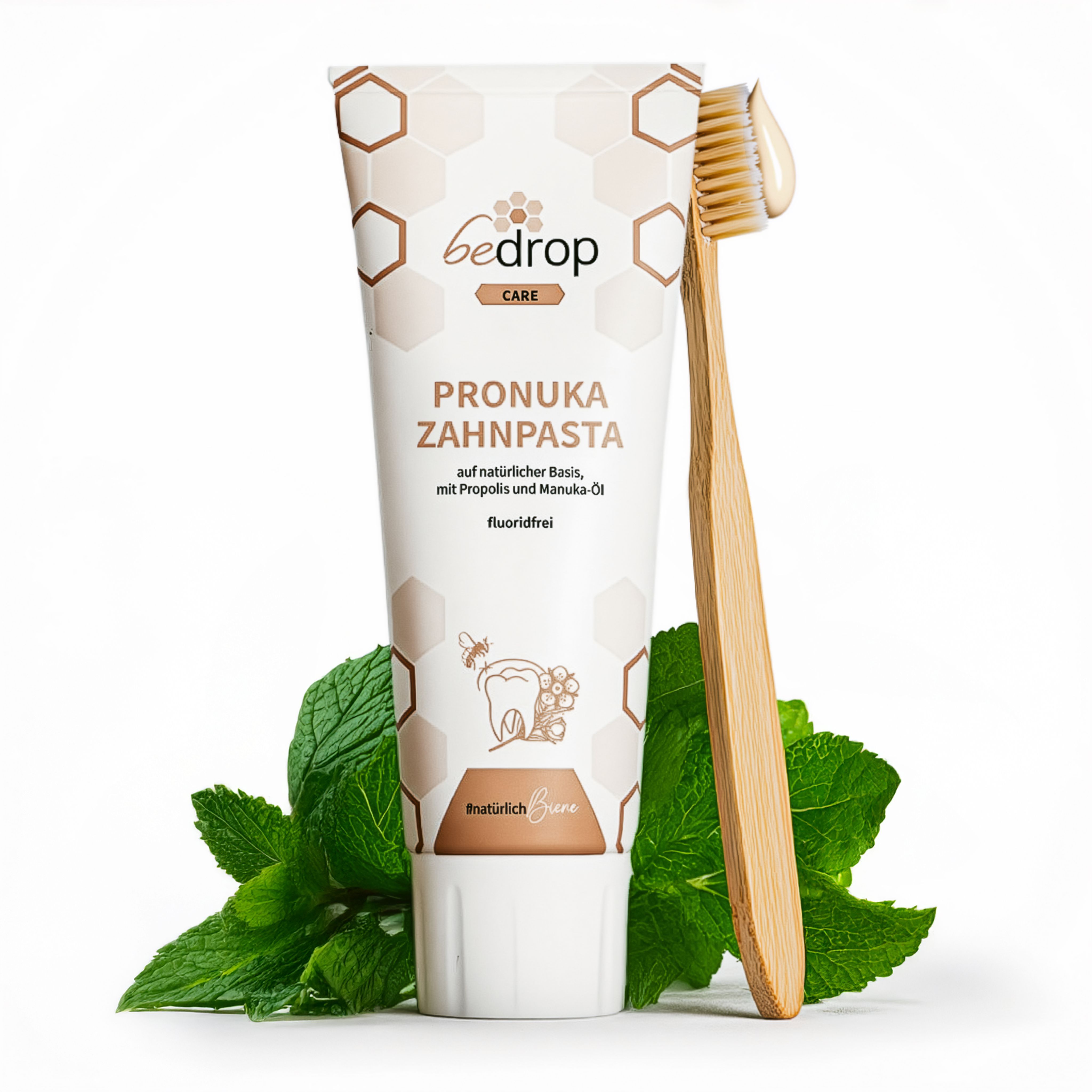 Zahnpasta-Tube und Zahnbürste. Tube mit Produktnamen und Schriftzug. Zahnbürste mit Zahnpasta. Minzblätter im Hintergrund.