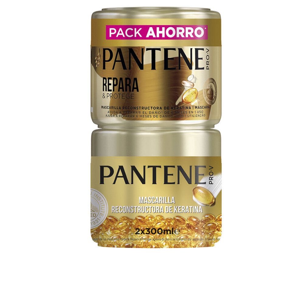 Zwei goldfarbene Tiegel, übereinander gestapelt. Aufschrift: PANTENE PRO-V, REPARIERT & SCHÜTZT, MASKE. Unterer Tiegel: MASCHERA RECONSTRUCTORA DE KERATINA.