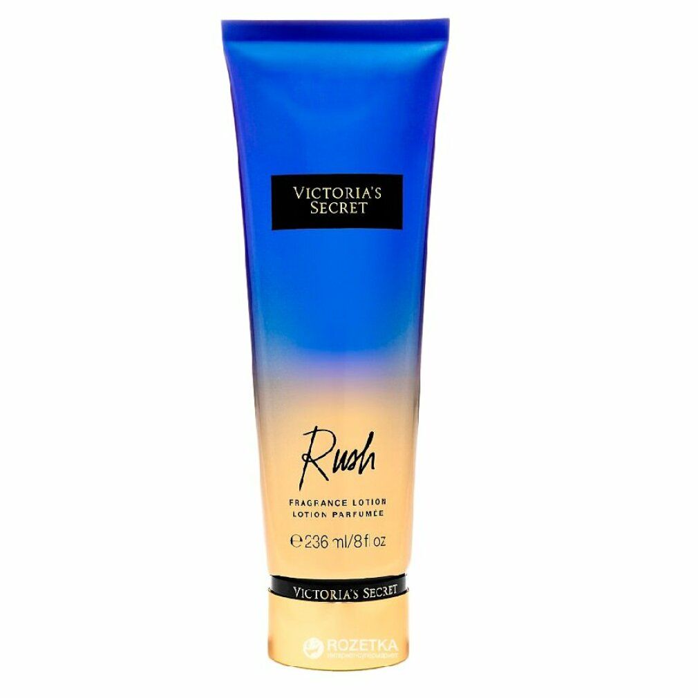 Blau-gelbe Tube. Schwarzes Rechteck mit "VICTORIA'S SECRET". Darunter "Rush" und "Fragrance Lotion". Untere Hälfte goldfarben.