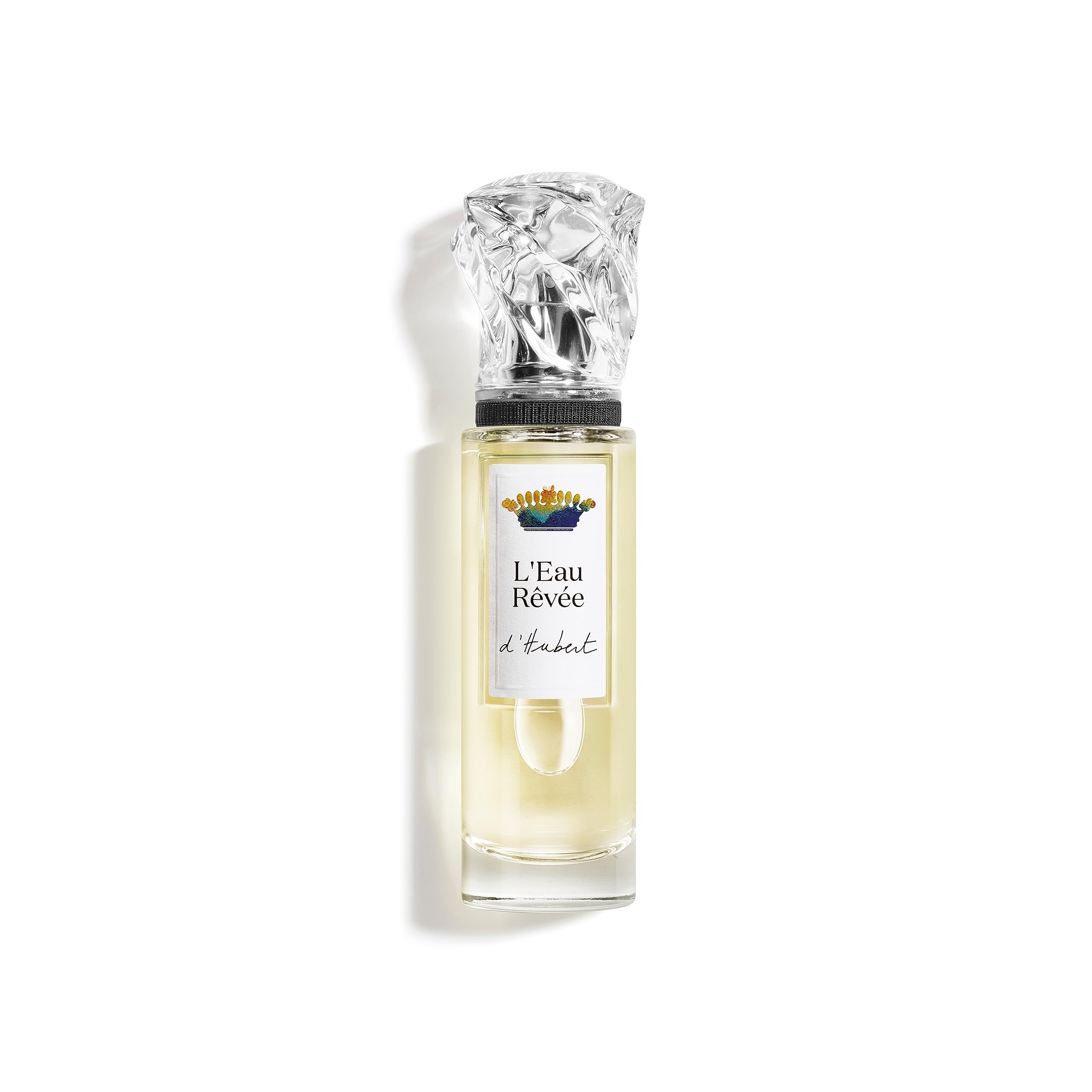 Flakon mit transparentem Glas, silbernem Verschluss und Etikett mit Schriftzug L'Eau Rêvée d'Hubert. Flüssigkeit hellgelb.
