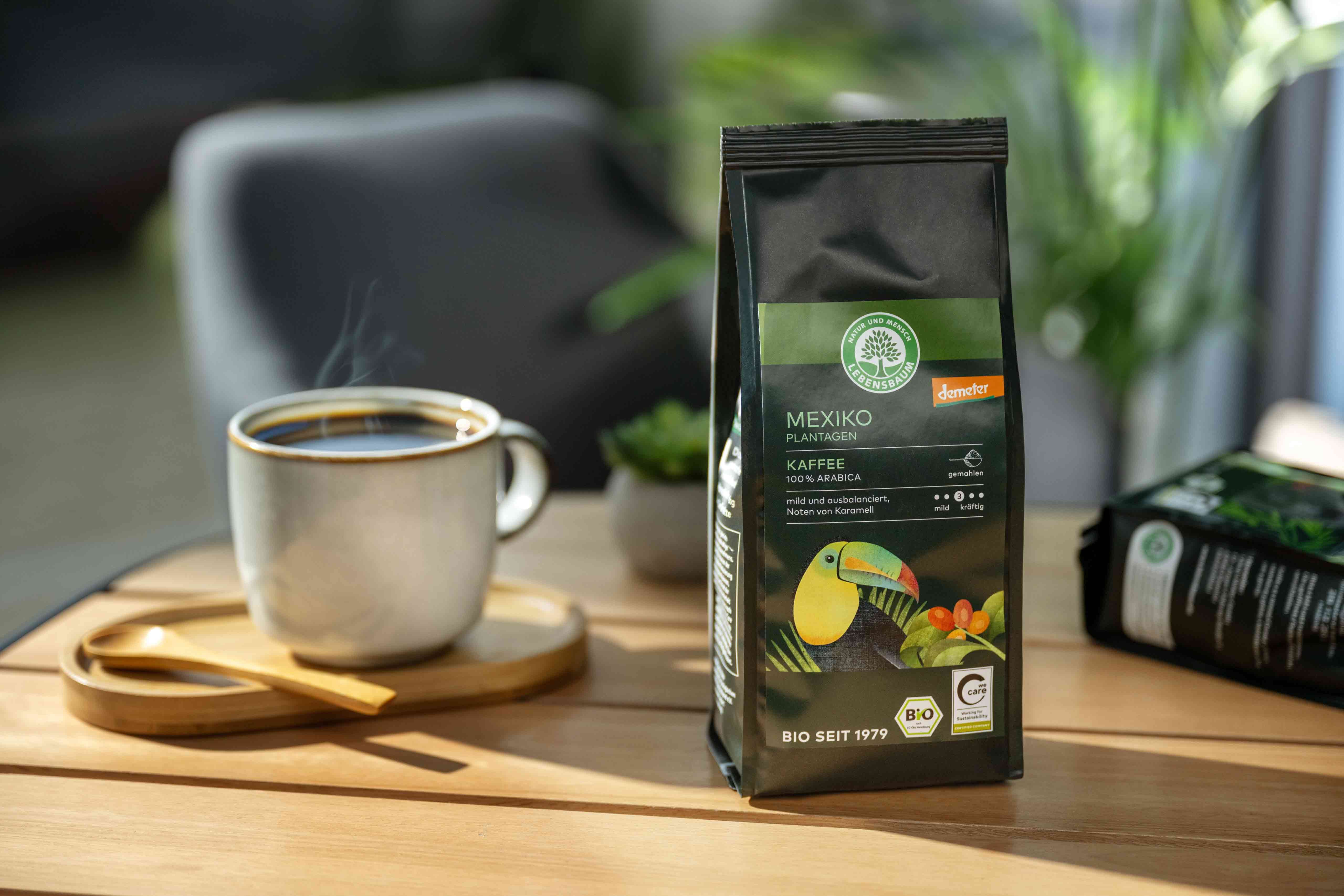Schwarzer Kaffeebeutel mit "Mexiko Kaffee" Aufschrift und einem Bild von einem Tukan. Daneben eine Tasse dampfenden Kaffees.