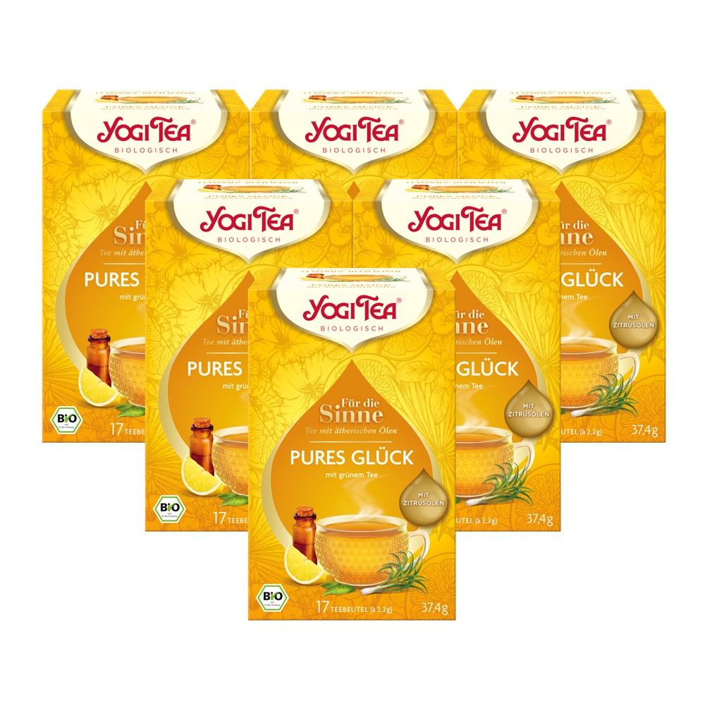 Mehrere Packungen Yogi Tea, gelb-goldene Verpackung. Aufdruck: Pures Glück, Bio-Kräutertee. Logo: Yogi Tea.