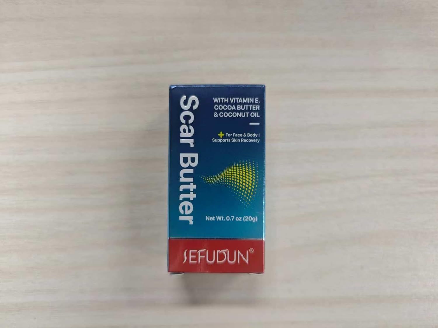 Karton mit Produktaufschrift "Scar Butter" und "SEFUDUN". Enthält Vitamin E, Kakaobutter und Kokosöl. Für Gesicht & Körper.