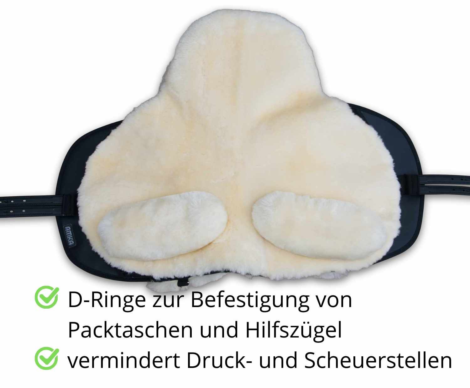 Baumloser Sattel mit Lammfellauflage. Schwarze Unterseite. D-Ringe zur Befestigung. Text: D-Ringe, vermindert Druck.