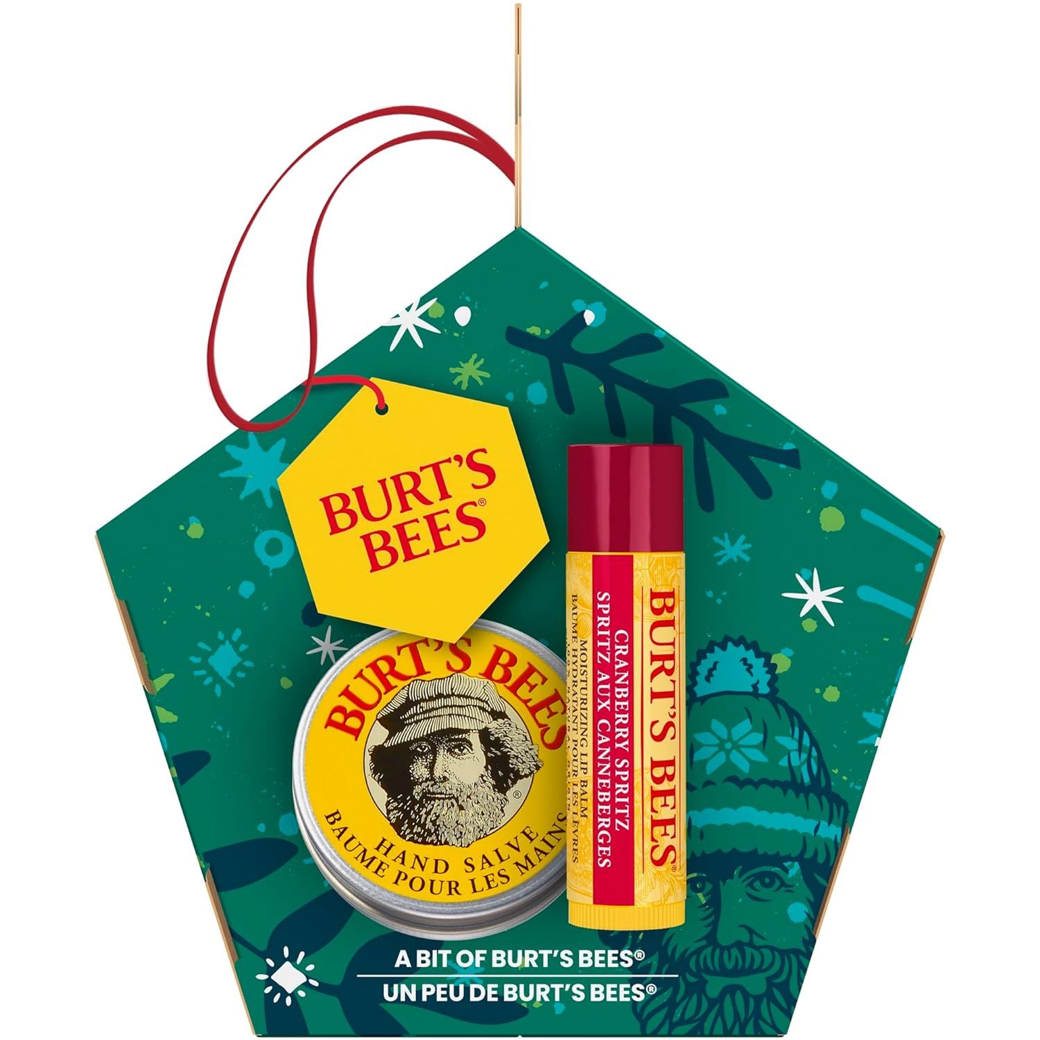 Geschenkset mit Lippenbalsam und Handbalsam. Verpackung in Form eines Fünfecks mit Aufhängung. Gelbes Etikett mit Logo.