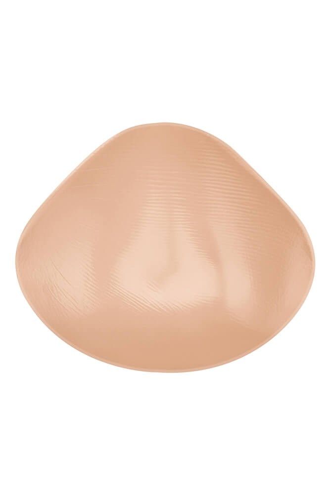 Hautfarbene Brustprothese, flache Form mit geriffelter Oberfläche. Runde Form.
