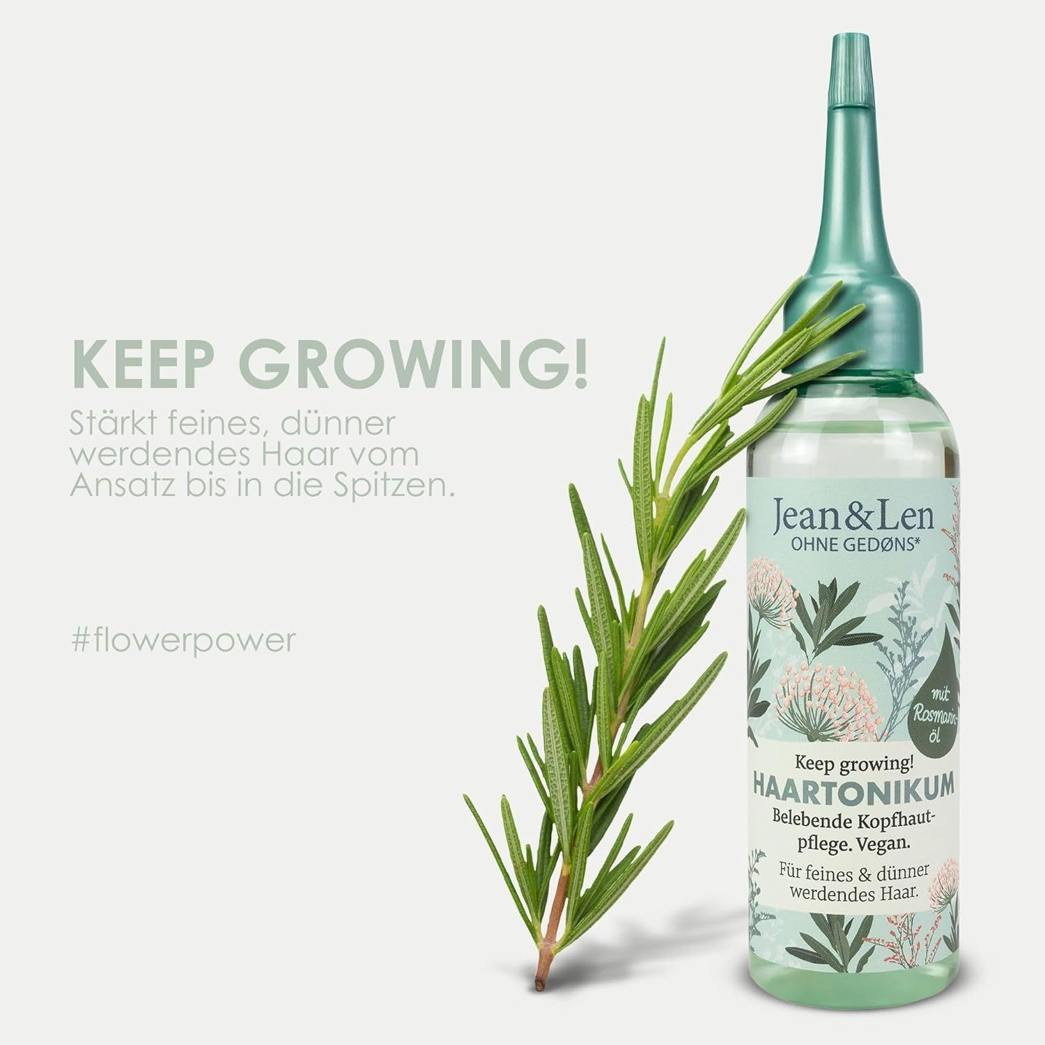 Haartonikum-Flasche mit Rosmarinzweig. Flasche mit grünem Deckel und Etikett. Text: Keep growing! Haartonikum, Rosmarinöl, Vegan.
