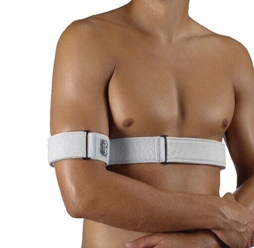 Schulterfixationsbandage, weiß, am Oberkörper eines Mannes befestigt. Bandage mit Klettverschluss und Handgelenkstütze.