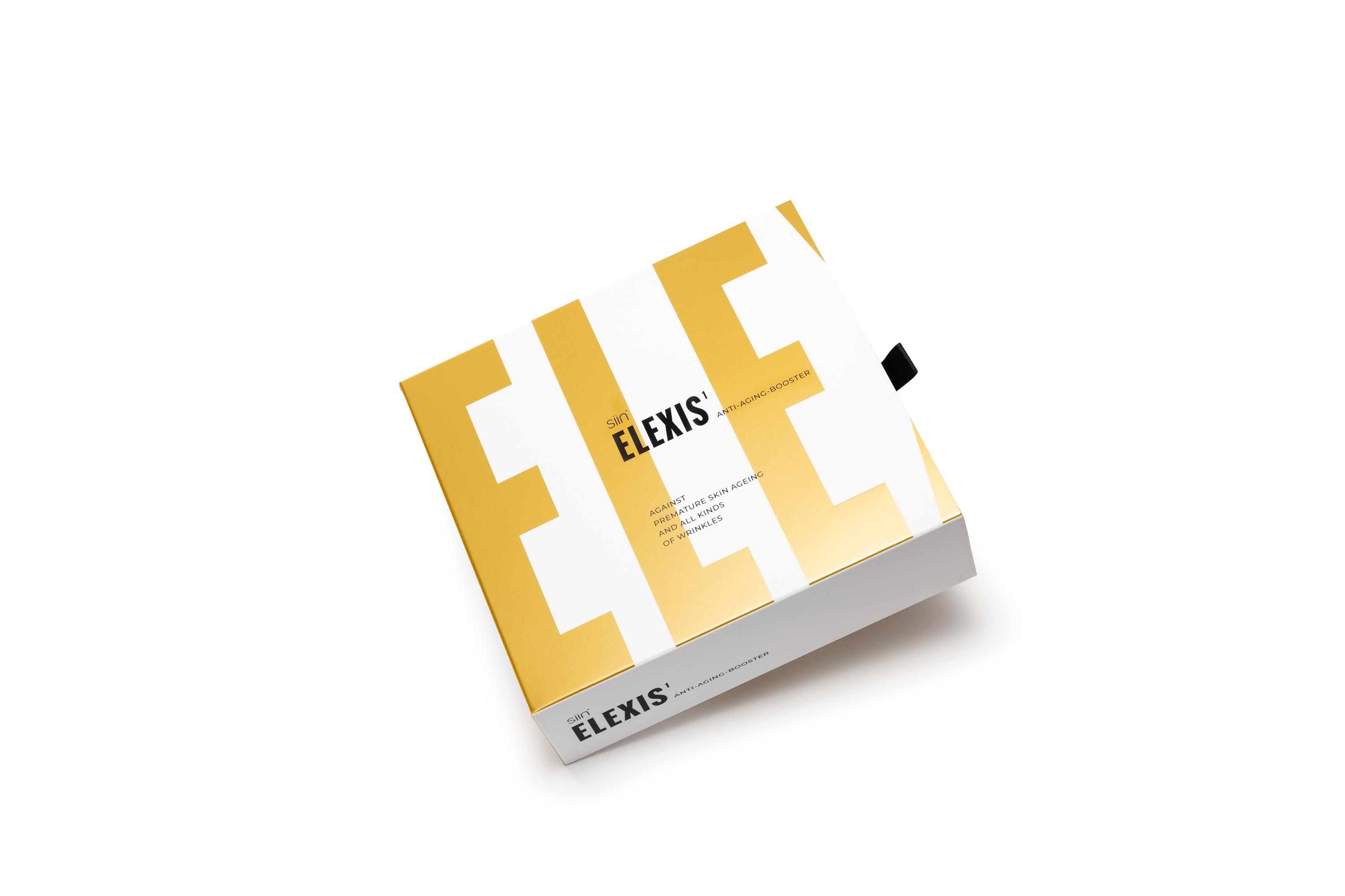 Verpackung mit gelbem und weißem Design. Aufschrift: ELEXIS. Schwarzer Bandverschluss.
