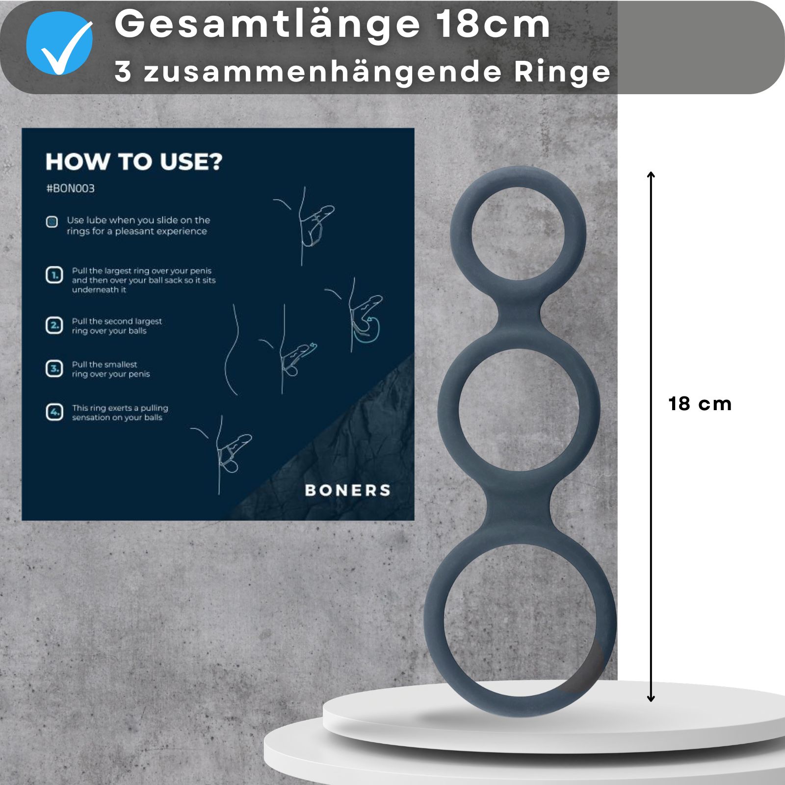 Penisring mit drei Ringen. Text: Gesamtlänge 18cm, 3 zusammenhängende Ringe. Anleitung und Produkt auf Podest.