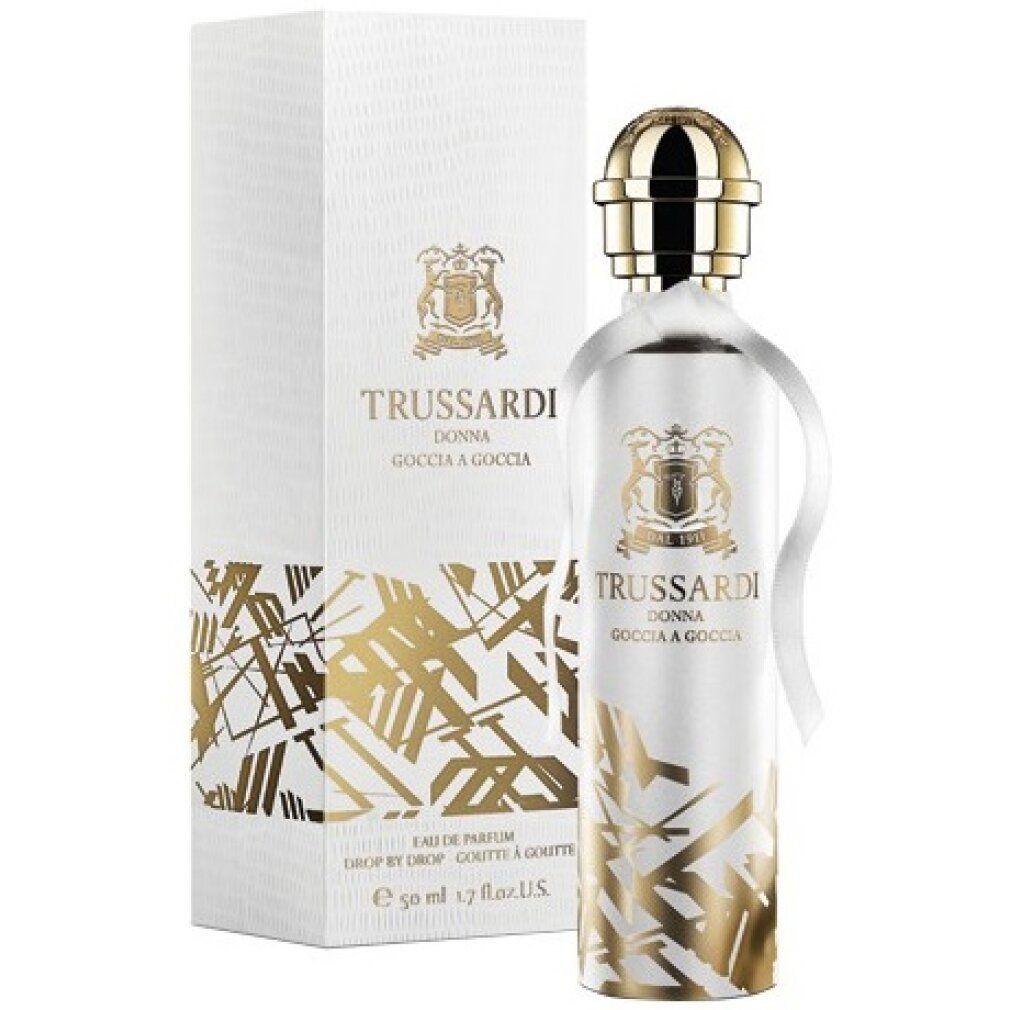 Parfümflasche und Verpackung. Marke: Trussardi Donna Goccia a Goccia. Goldene Details. Flasche mit goldenem Deckel und weißem Band.