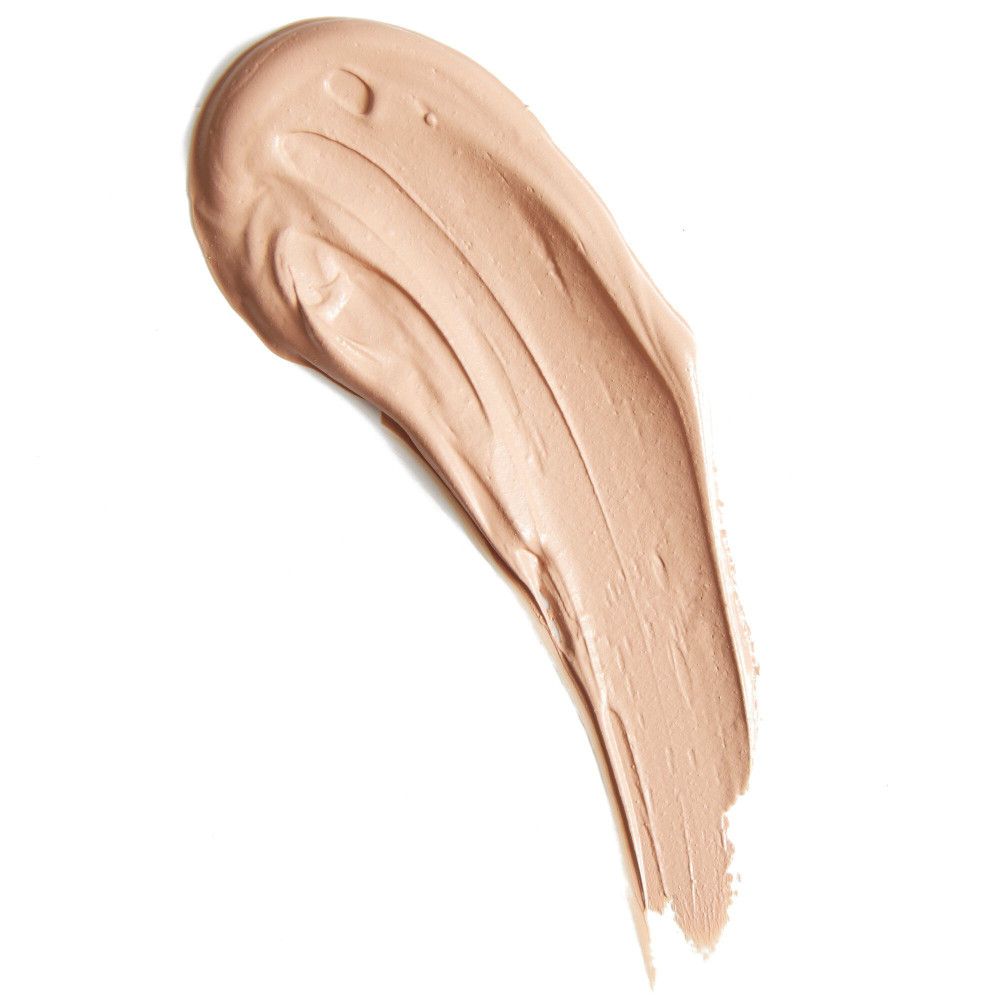 Heller Concealer-Farbton auf weißem Hintergrund. Cremige Textur, wellenförmiger Auftrag.