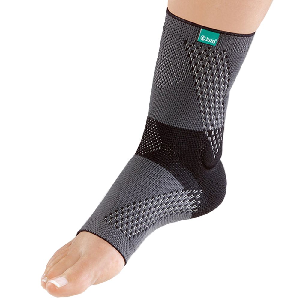 Achillessehnenbandage in Grau und Schwarz. Das Produkt bedeckt den Knöchel und den Fuß. Das Logo "juzo" ist sichtbar.