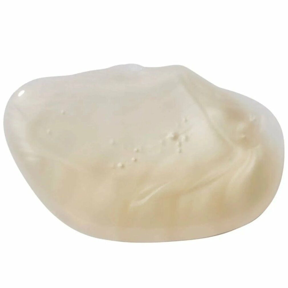 Nahaufnahme einer cremefarbenen Shampoo-Gel-Textur. Glänzende, leicht transparente Masse.