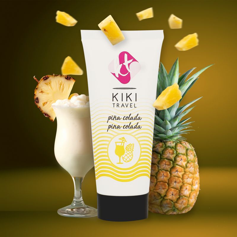 Weiße Tube mit schwarzem Deckel. Aufschrift: KIKI TRAVEL, pina colada. Daneben Cocktail, Ananas und Ananasstücke.