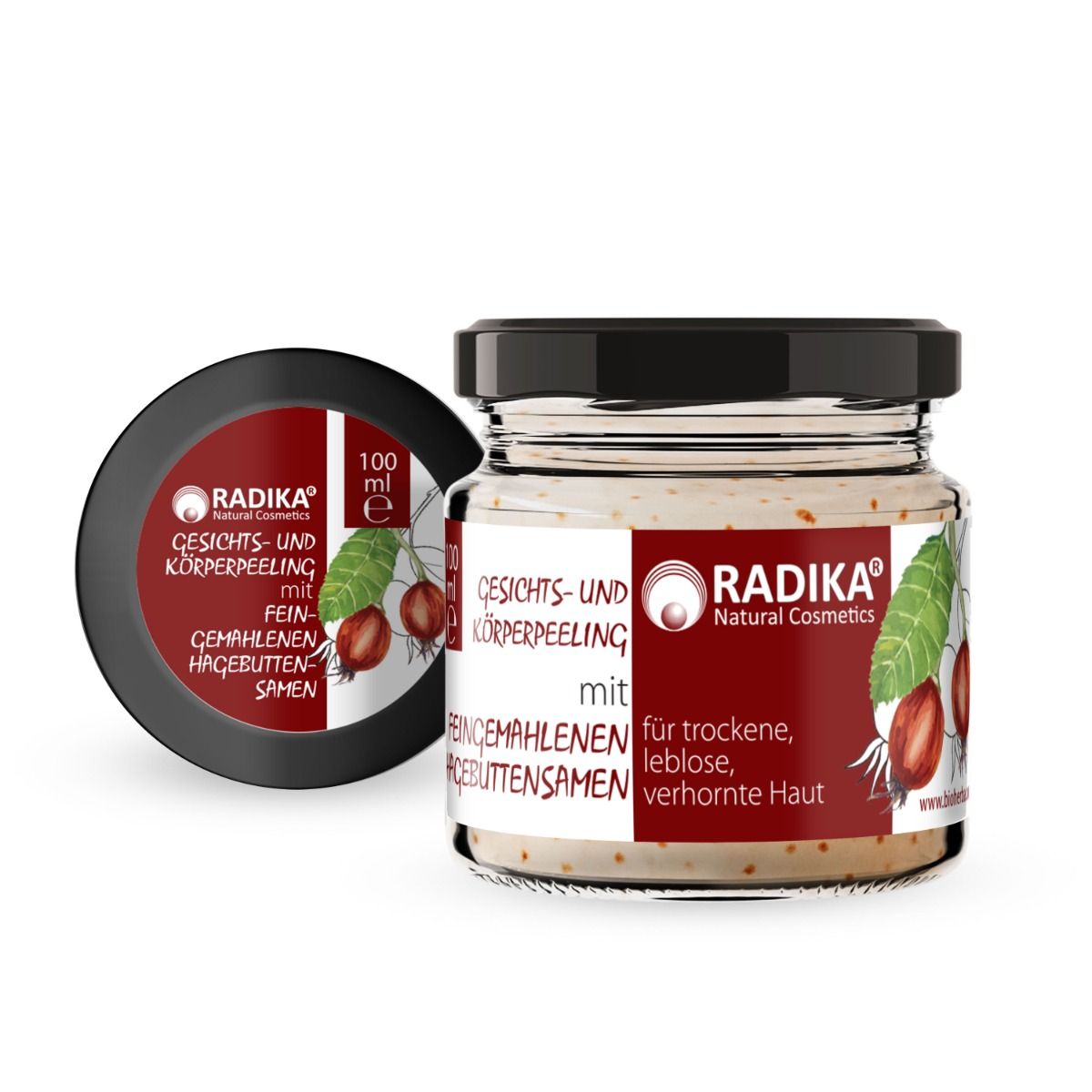 Glas mit Peeling, schwarzem Deckel. Etikett mit Produktname, Marke und Hagebuttensamen-Illustration. 100 ml.