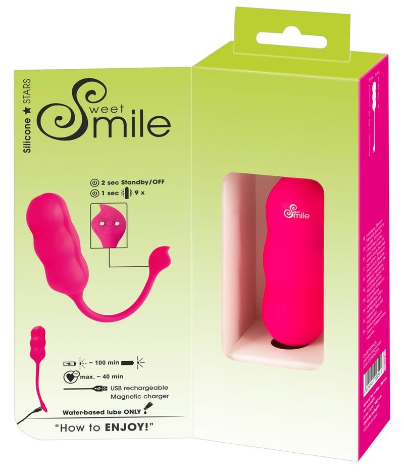 Pinkfarbener Vaginaltrainer in Verpackung. Aufgedruckt: Sweet Smile, Ladeinformationen, USB-Ladekabel.