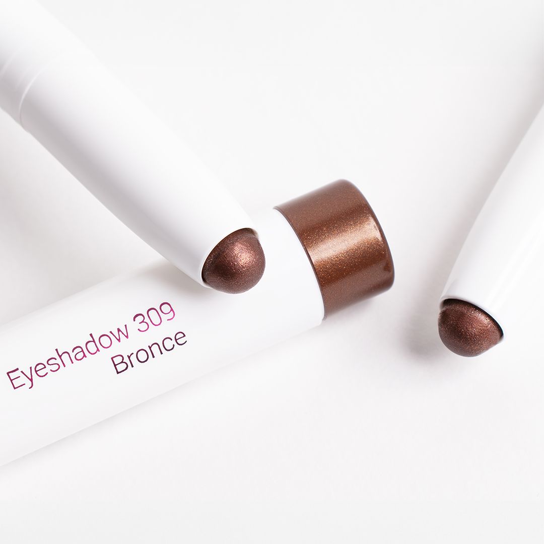 Zwei weiße Stifte mit Bronze-Lidschatten von Cosline. Aufschrift: Eyeshadow 309 Bronce. Produkt-Enden in Bronze-Farbe.