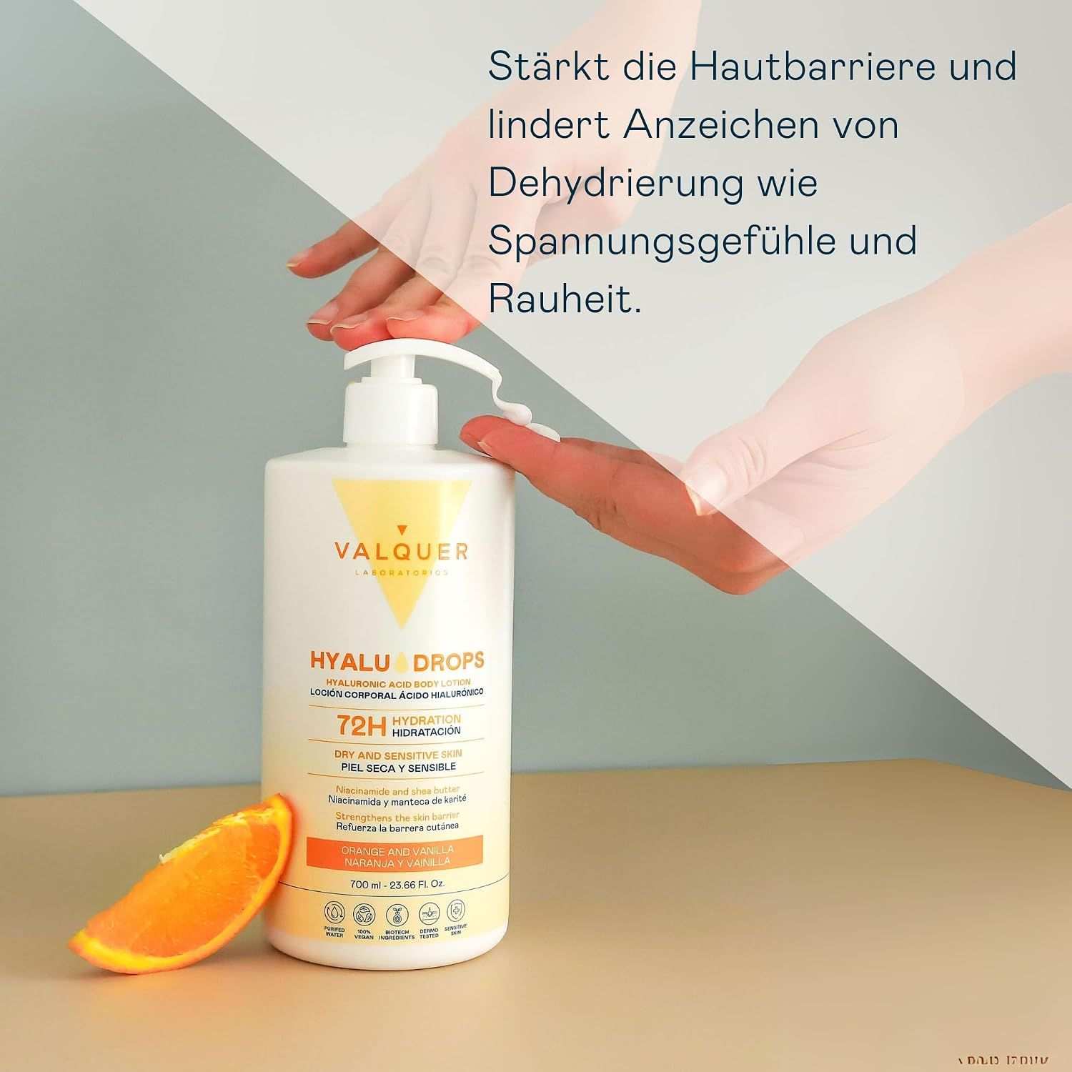 Spender Valquer Hyalu Drops mit Orangenscheibe und Händen.