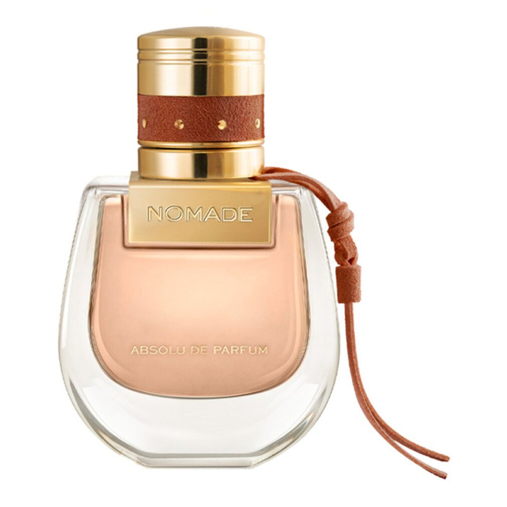 Parfümflakon mit goldfarbenem Deckel, braunem Lederband. Aufschrift 'Nomade Absolu de Parfum'. Transparenter Flakon.
