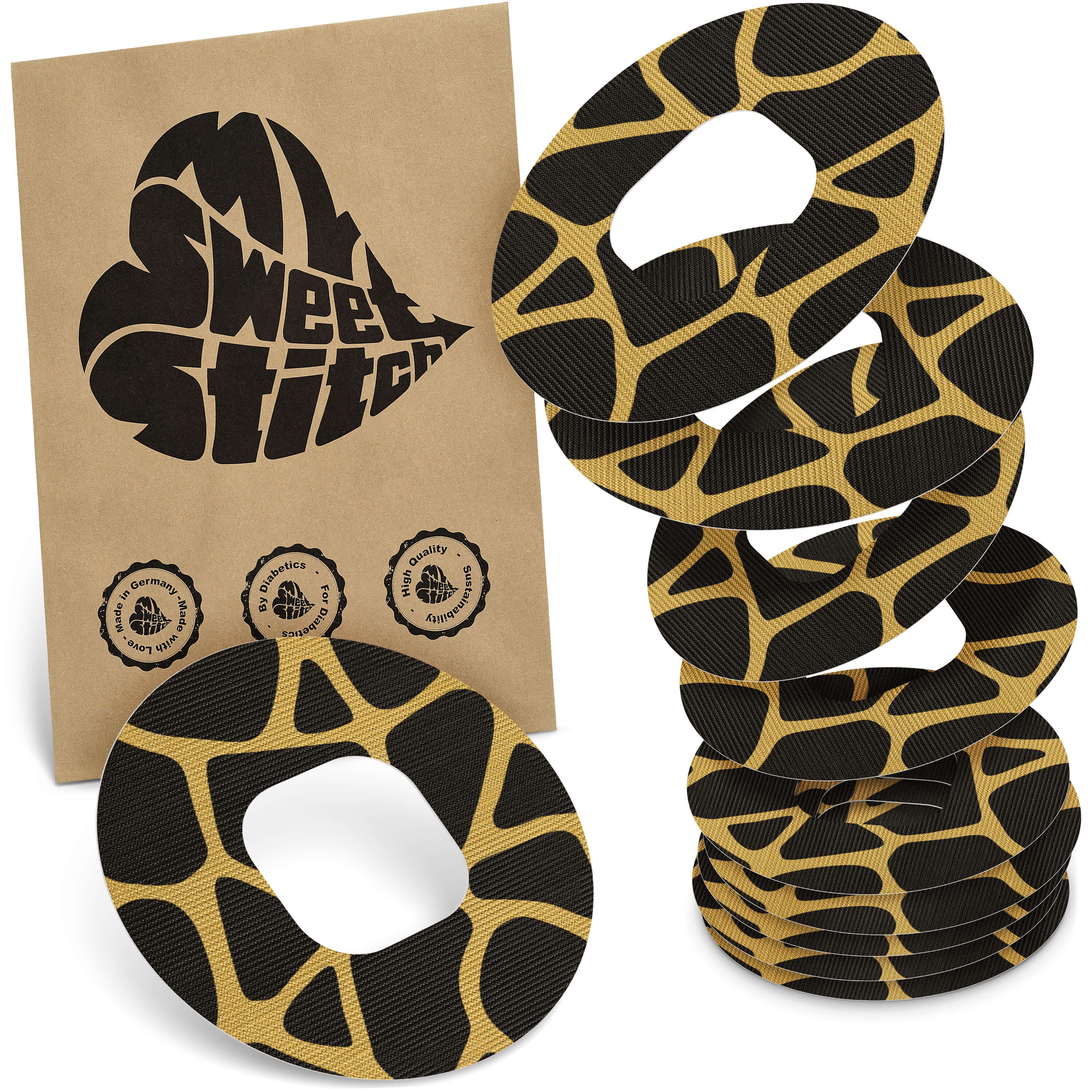 Mehrere runde Pflaster mit schwarzem und beigem Muster. Eine Packung mit Logo und Qualitätssiegeln. Marke: MySweetStitch.