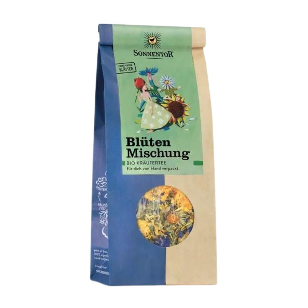 Sonnentor Blütenmischung Tee-Packung. Grün-braune Papiertüte mit Sichtfenster. Aufdruck mit Blumenmotiv und Produktbezeichnung.