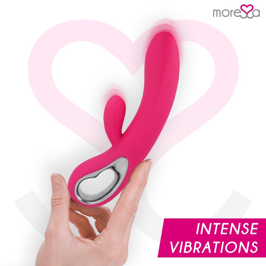 Hand hält pinkfarbenen Silikon-Vibrator mit silbernem Ring. Text: Intense Vibrations.