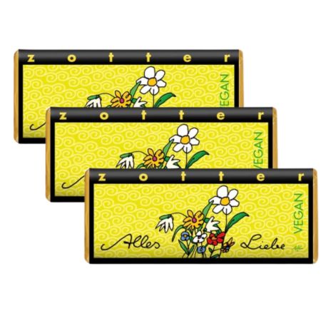 Drei Schokoladentafeln mit gelbem Hintergrund und Blumenmuster. Aufschrift: Zotter, Alles Liebe, Vegan.