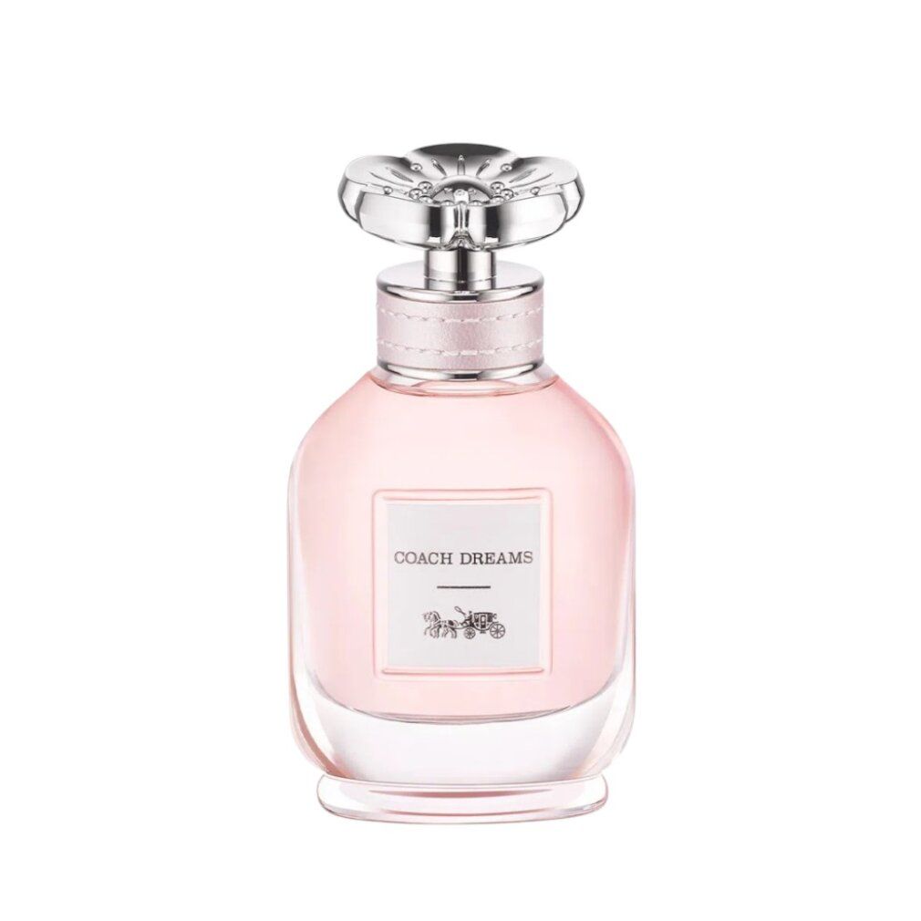 Parfümflasche mit rosa Flüssigkeit. Etikett "COACH DREAMS" und Kutschenlogo. Transparenter Deckel.