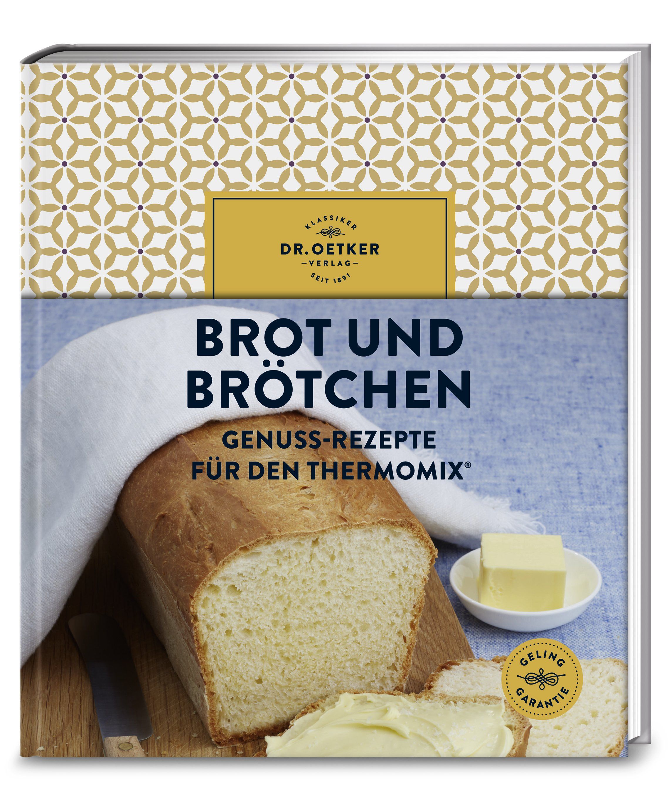 Kochbuch "Brot und Brötchen" von Dr. Oetker. Aufgeschlagen mit Brot, Butter und Messer. Goldfarbenes Muster auf dem Einband.