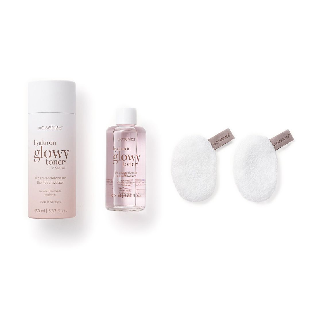 Drei Produkte: eine Flasche, eine kleinere Flasche und zwei Pads. Alle Produkte sind weiß und rosa.