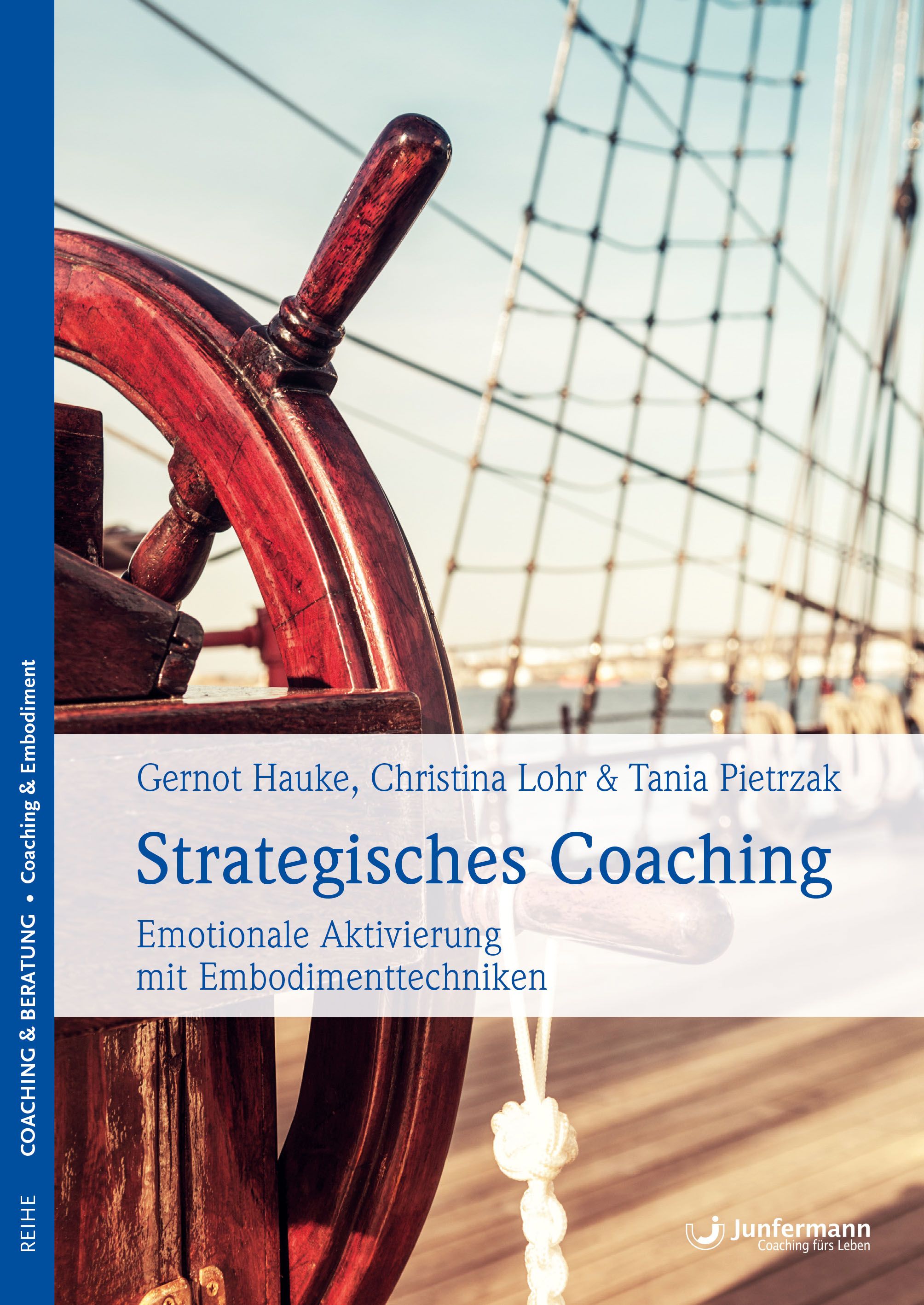 Buchcover mit dem Titel "Strategisches Coaching". Autoren: Hauke, Lohr, Pietrzak. Untertitel: Emotionale Aktivierung mit Embodimenttechniken. Im Hintergrund: Steuerrad.
