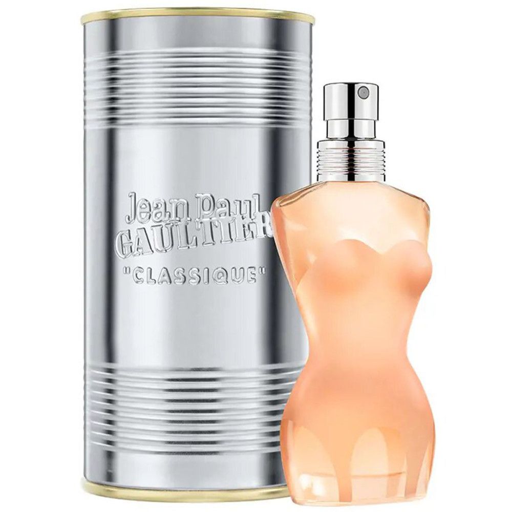 Parfümflakon in Frauenkörperform neben silberner Dose. Aufschrift: Jean Paul Gaultier, Classique. Silberner Zerstäuber.