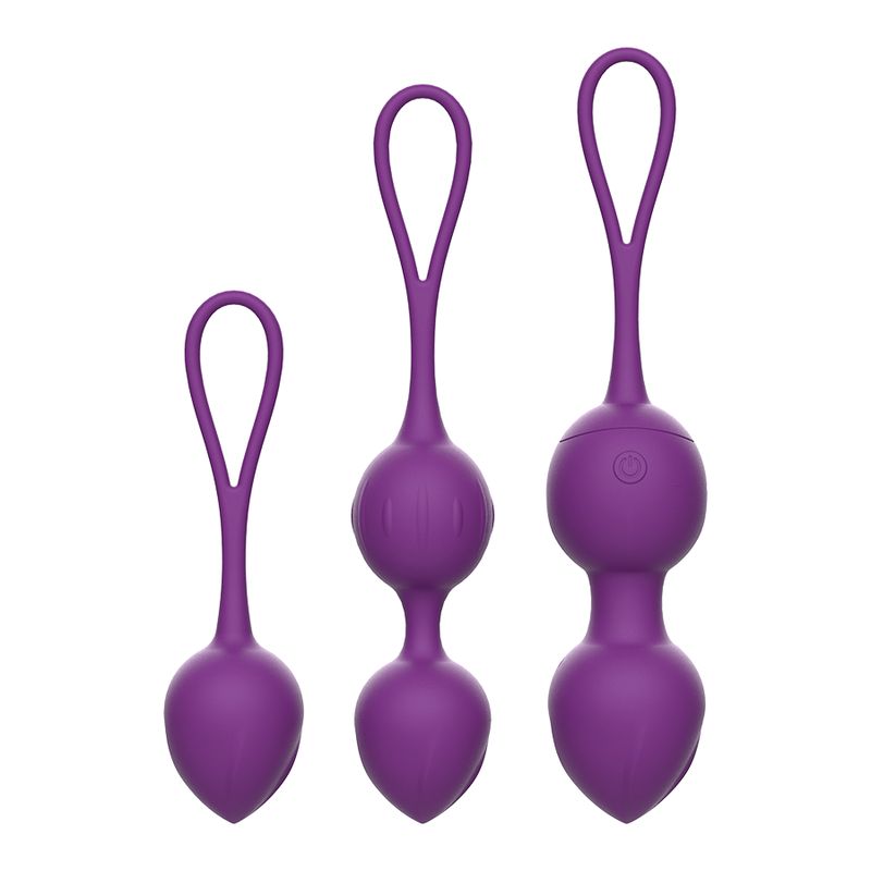 Drei lila Vibro-Bälle mit Schlaufen. Ein Ball hat einen Ein-/Ausschalter.