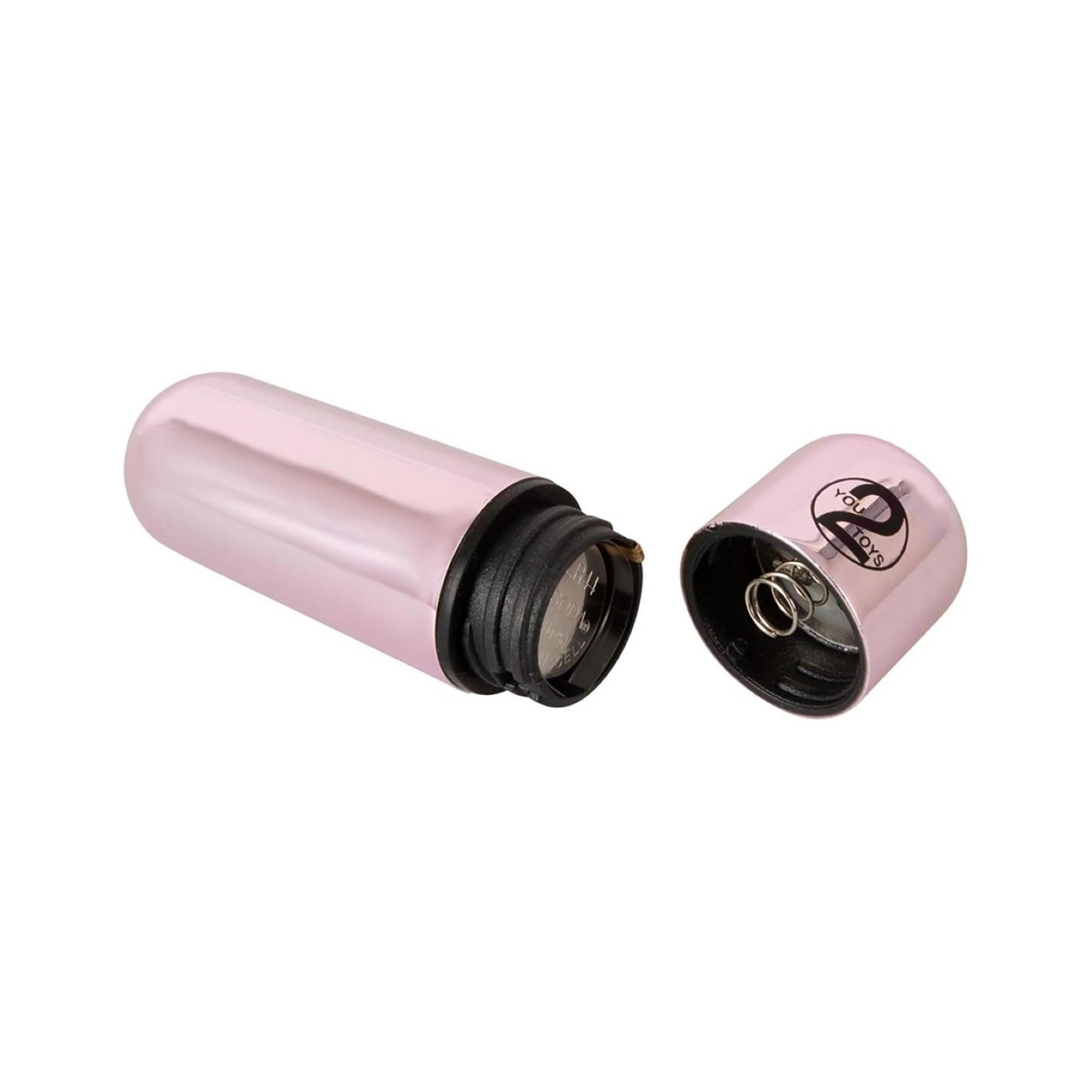 Pinkfarbener Vibrator mit goldfarbenem Element. Geöffnet, zeigt Batteriefach und Feder.