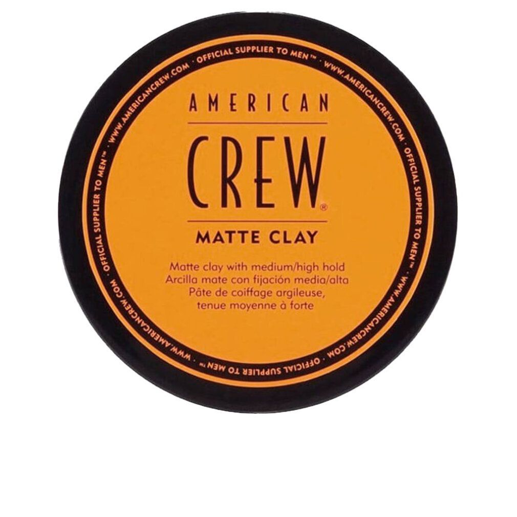 Runde, schwarze Dose mit orangefarbenem Deckel. Schwarzer Schriftzug: AMERICAN CREW. Text: Matte Clay, Medium/High Hold, Matte Finish.