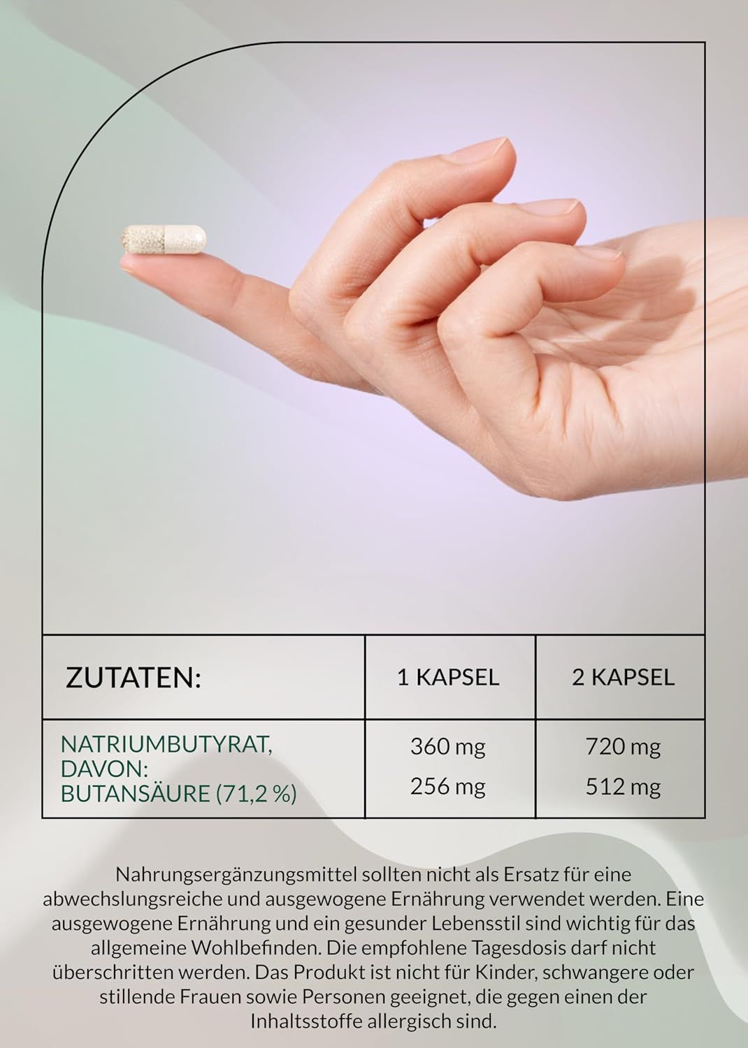 Eine Hand hält eine Kapsel mit Natriumbutyrat.