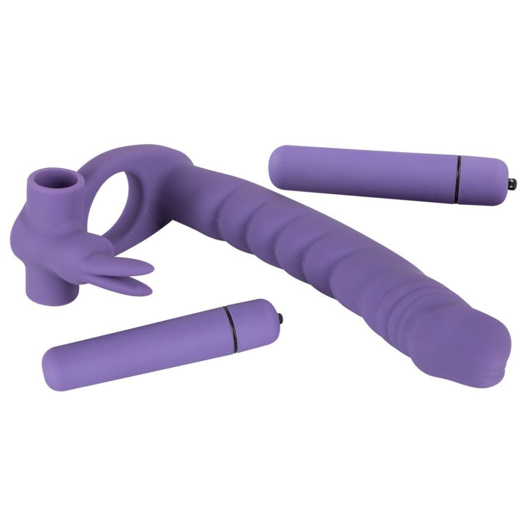Lila Penisring mit Dildo und zwei Vibratoren. Geriffelte Oberfläche. Ring mit Noppen und Vibrationsfunktion. Vibratoren zylindrisch.