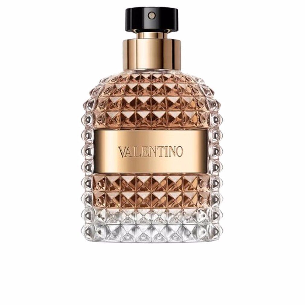 Parfümflakon mit goldfarbenen Elementen und geprägtem Glas. Aufschrift Valentino. Auf weißem Hintergrund.
